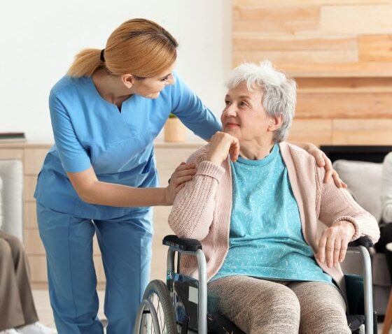 nurses assisting elderly people at retirement home