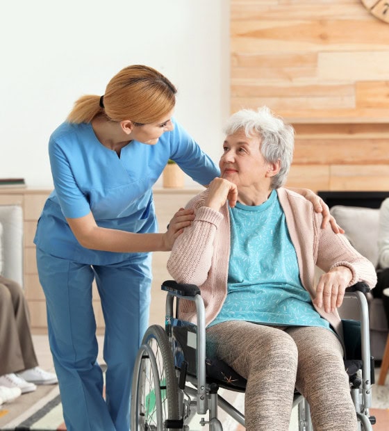 nurses assisting elderly people at retirement home